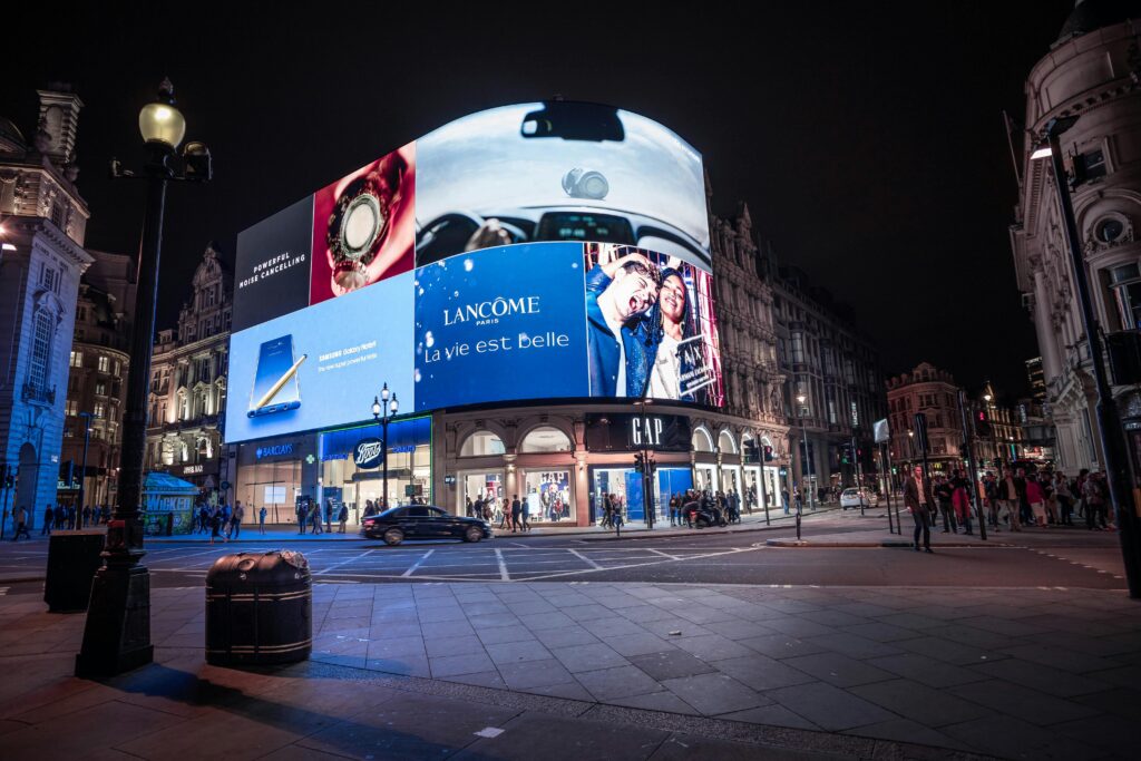 Night view of illuminated billboards at Piccadilly Circus, showcasing vibrant city life in London.